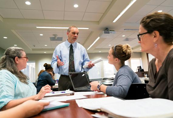 Image of adult students in classroom discussion.